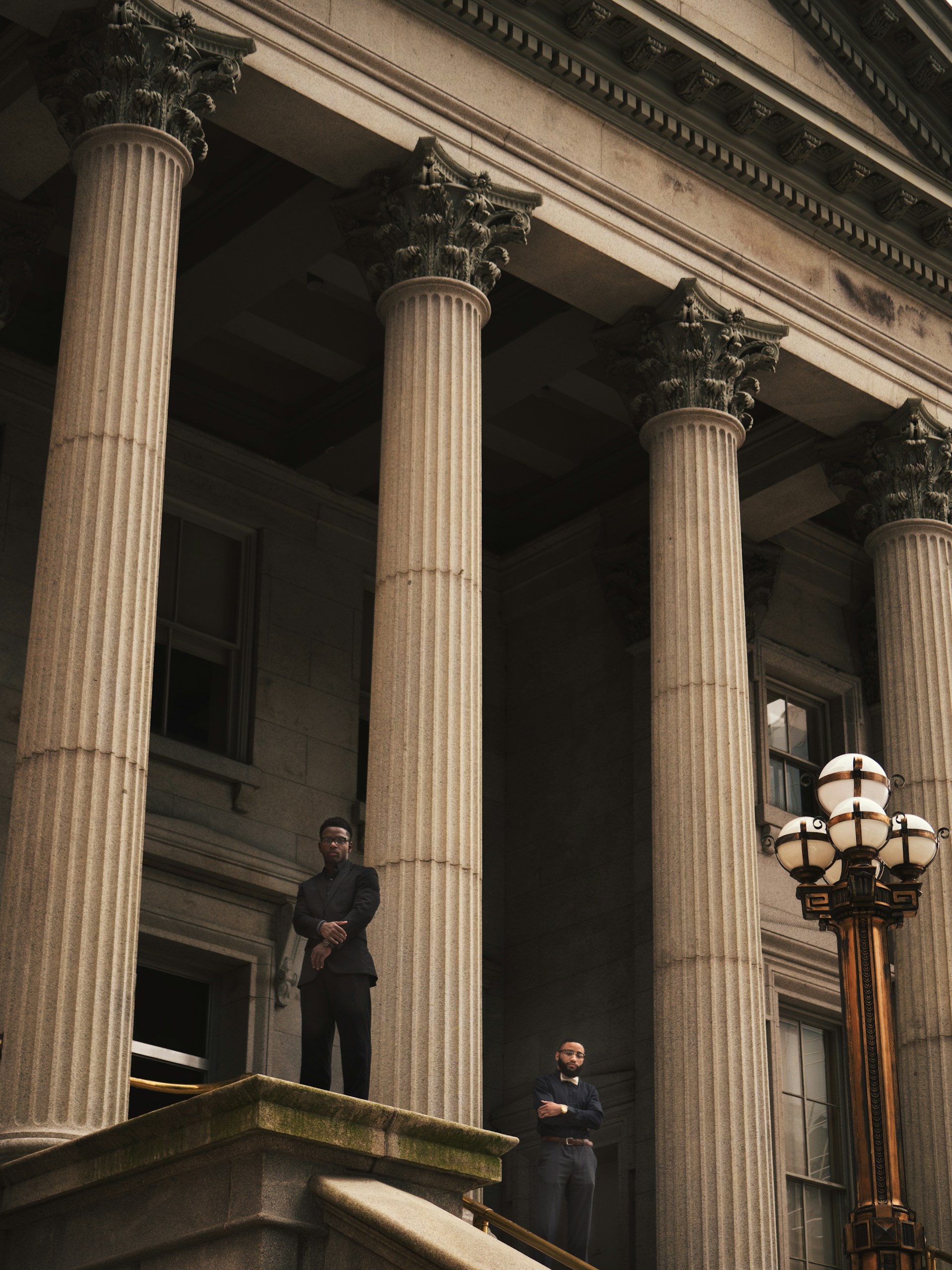 Two attorneys beneath courthouse columns — Pónt AI, the case operating system for personal injury